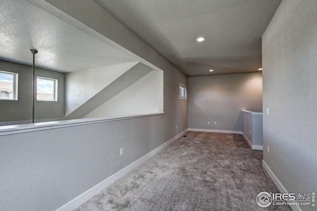 basement with carpet and a textured ceiling