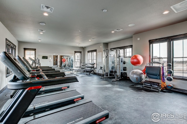 exercise room featuring a textured ceiling