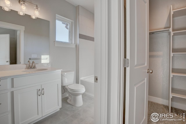 bathroom with toilet, tile patterned flooring, and vanity