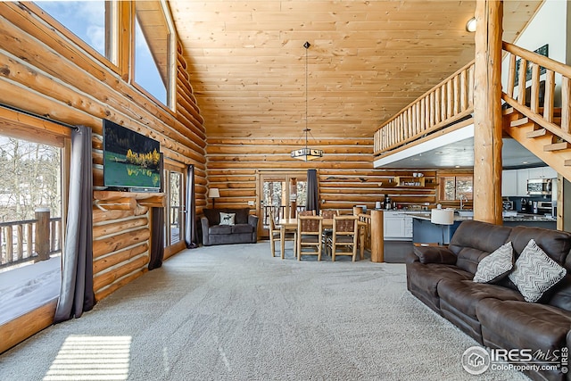 living area with high vaulted ceiling, log walls, carpet, wooden ceiling, and healthy amount of natural light
