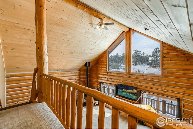 hallway featuring rustic walls, wood ceiling, an upstairs landing, carpet flooring, and high vaulted ceiling