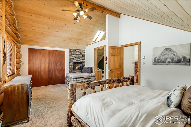bedroom with wooden ceiling, carpet, a stone fireplace, and high vaulted ceiling