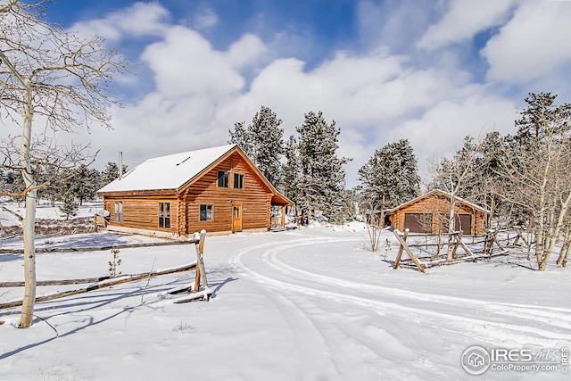 snowy yard featuring an outdoor structure