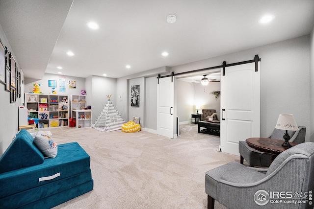 living area with light carpet, ceiling fan, and baseboards