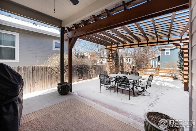 snow covered rear of property featuring fence and a pergola