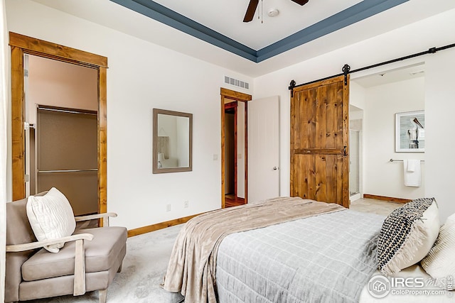 bedroom with visible vents, carpet flooring, baseboards, a barn door, and ceiling fan