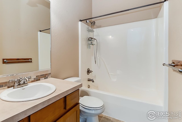 bathroom with tasteful backsplash, vanity, tub / shower combination, and toilet