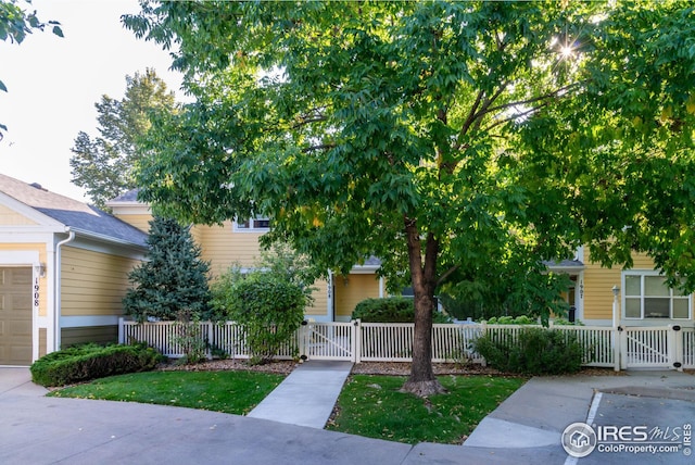 exterior space with a fenced front yard and a gate