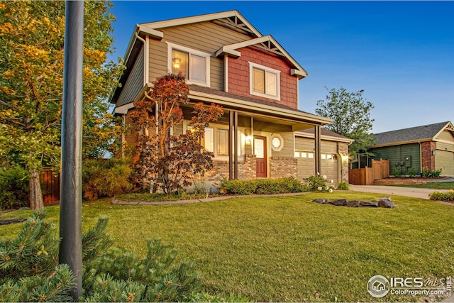 view of front of home with concrete driveway, a front lawn, and brick siding