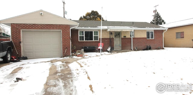 single story home with a garage and brick siding