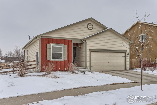 view of front of house featuring board and batten siding, driveway, and an attached garage