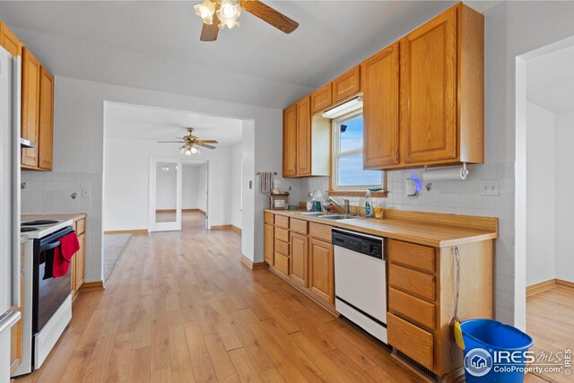24525 County Road 53, Kersey, CO 80644 - kitchen with tasteful backsplash, white appliances, light countertops, and light wood finished floors