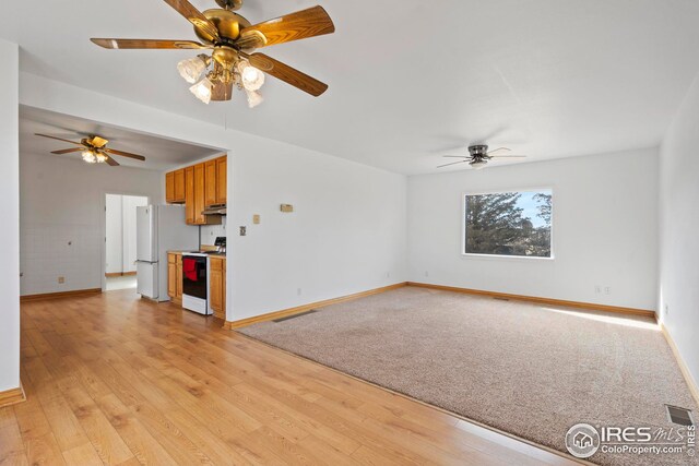 24525 County Road 53, Kersey, CO 80644 - unfurnished living room featuring a ceiling fan, visible vents, light wood-style flooring, and baseboards