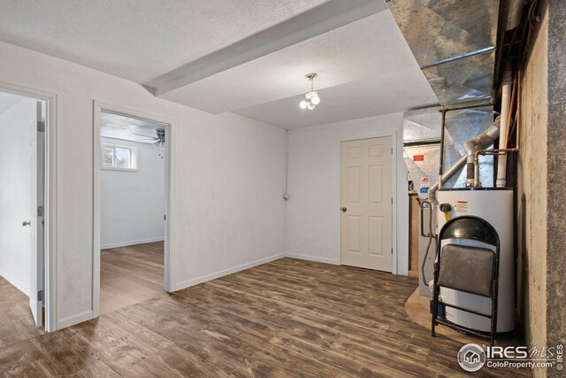 24525 County Road 53, Kersey, CO 80644 - below grade area featuring a textured ceiling, wood finished floors, and baseboards