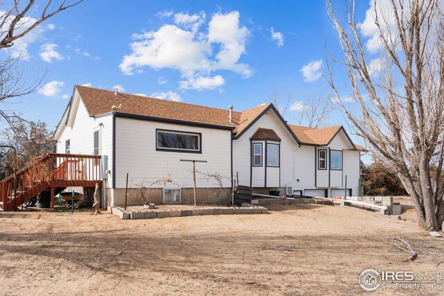 24525 County Road 53, Kersey, CO 80644 - rear view of property featuring stairs, roof with shingles, and a wooden deck