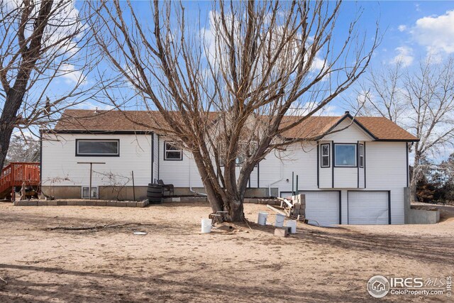 24525 County Road 53, Kersey, CO 80644 - view of front of home featuring a garage and dirt driveway