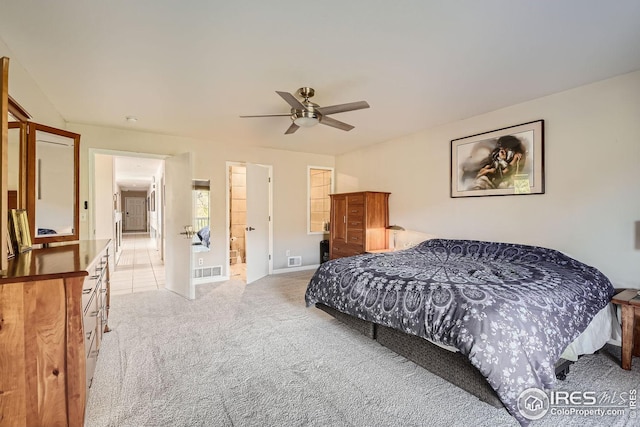 bedroom featuring light carpet, visible vents, and a ceiling fan