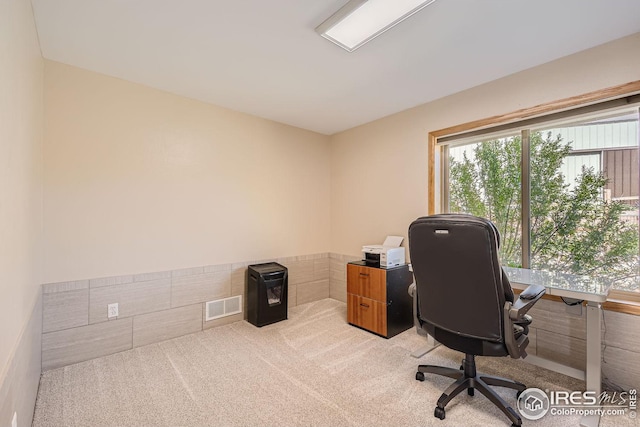 home office with light carpet and visible vents