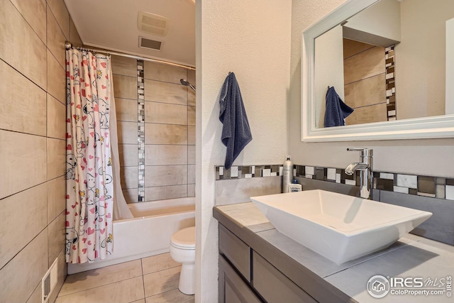 bathroom with visible vents, toilet, tile patterned floors, shower / bathtub combination with curtain, and vanity