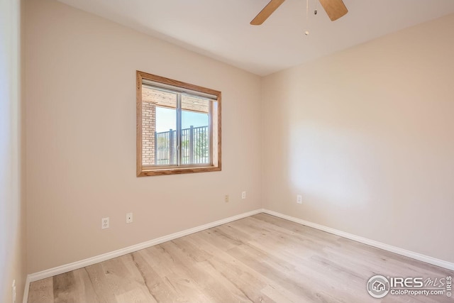 unfurnished room featuring ceiling fan, light wood-type flooring, and baseboards