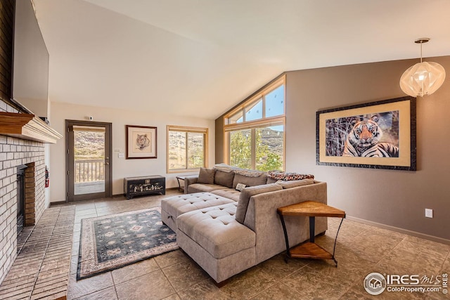 living area featuring high vaulted ceiling, plenty of natural light, a fireplace, and baseboards