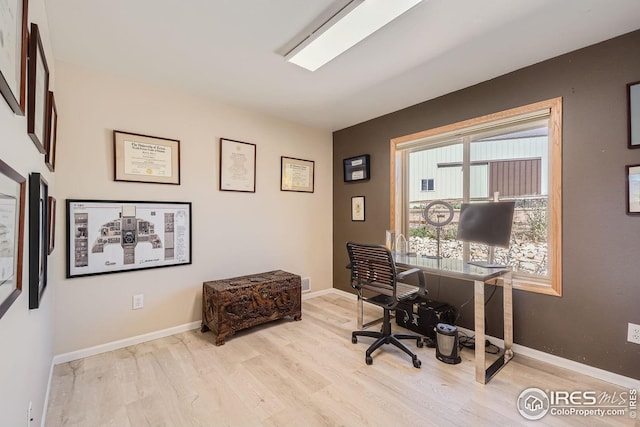 office space featuring light wood-type flooring and baseboards