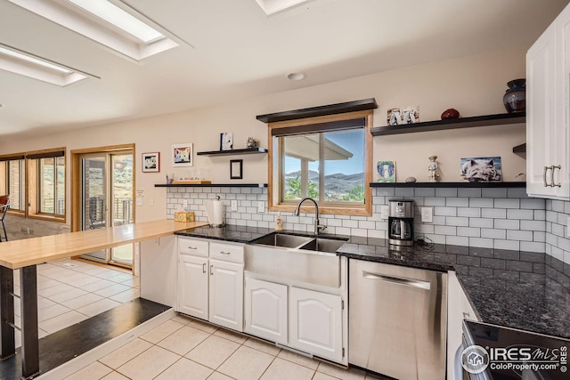 kitchen with light tile patterned floors, white cabinetry, open shelves, and dishwasher