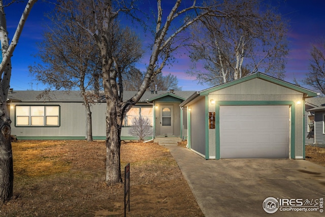 single story home with driveway and an attached garage