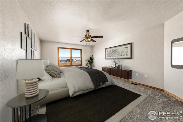 11837 County Road 39, Fort Lupton, CO 80621 - bedroom featuring carpet, a textured wall, ceiling fan, and a textured ceiling