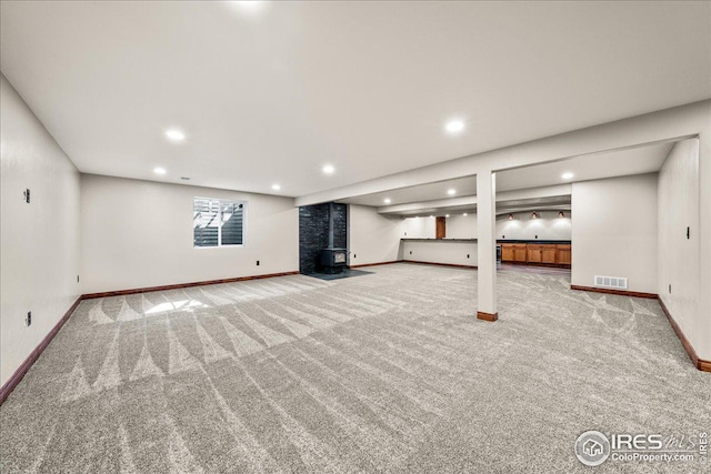 11837 County Road 39, Fort Lupton, CO 80621 - basement with carpet, a wood stove, and recessed lighting