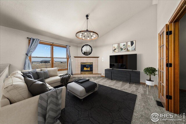 11837 County Road 39, Fort Lupton, CO 80621 - living area featuring a chandelier, vaulted ceiling, a tile fireplace, and carpet