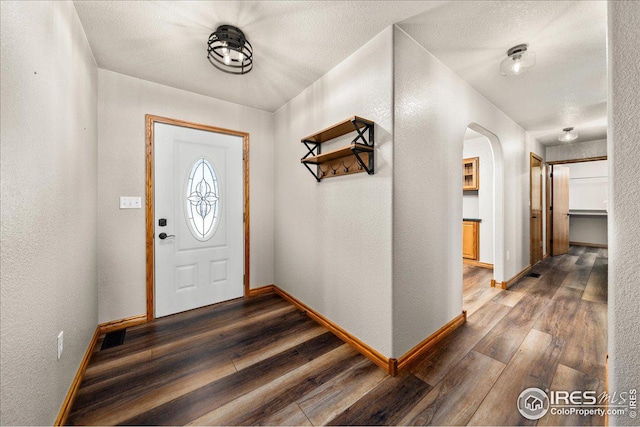 11837 County Road 39, Fort Lupton, CO 80621 - foyer entrance with hardwood / wood-style floors, arched walkways, and a textured wall
