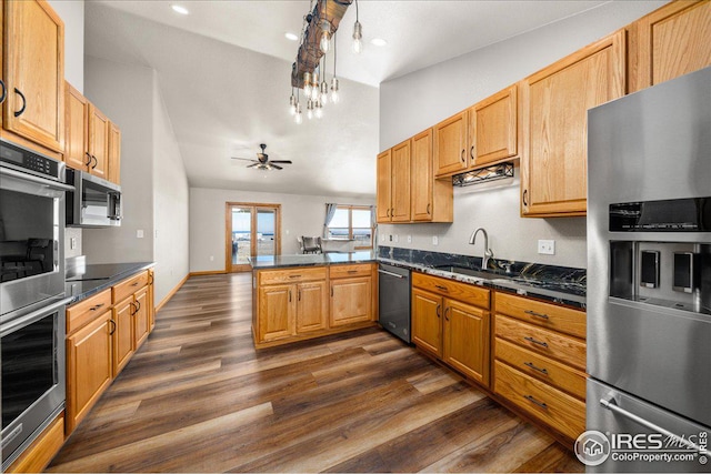 11837 County Road 39, Fort Lupton, CO 80621 - kitchen with appliances with stainless steel finishes, dark countertops, a peninsula, dark wood-style floors, and a ceiling fan