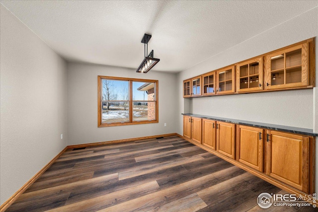 11837 County Road 39, Fort Lupton, CO 80621 - unfurnished dining area featuring dark wood-style floors and a textured ceiling