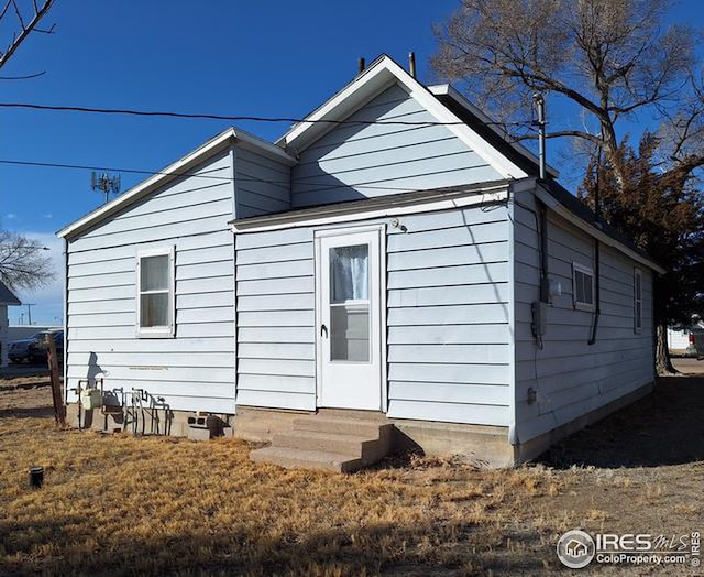 back of property featuring entry steps