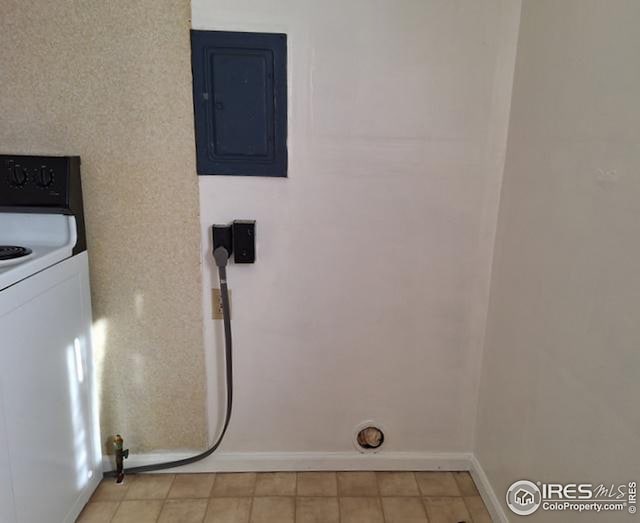 clothes washing area featuring laundry area, baseboards, electric panel, and washer / clothes dryer