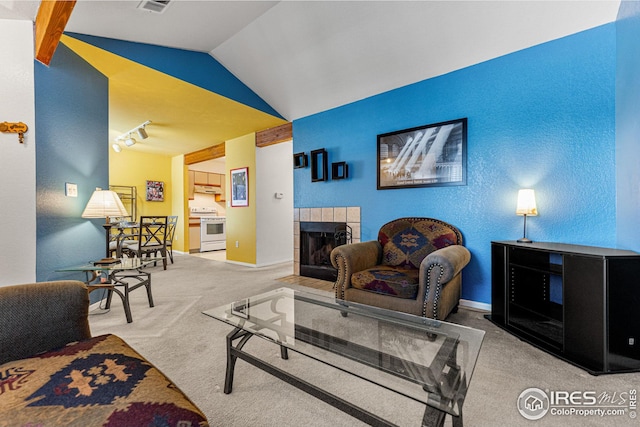 living room featuring lofted ceiling, carpet, visible vents, baseboards, and a tiled fireplace