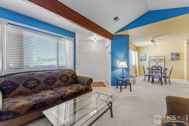 living area featuring lofted ceiling with beams, carpet flooring, visible vents, and baseboards