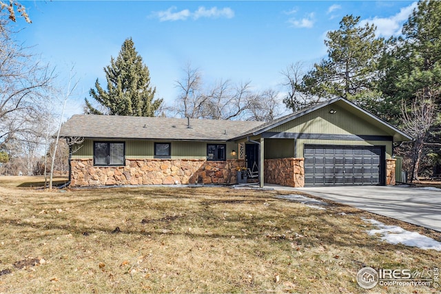 single story home featuring a garage, stone siding, a front lawn, and concrete driveway