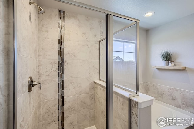 full bathroom with a stall shower, recessed lighting, and a bath