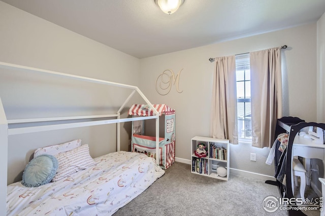 carpeted bedroom with baseboards