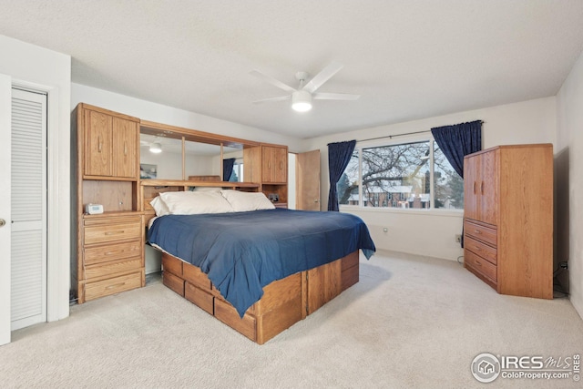 bedroom featuring light carpet and ceiling fan