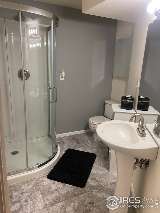 full bath with a shower stall, toilet, and baseboards