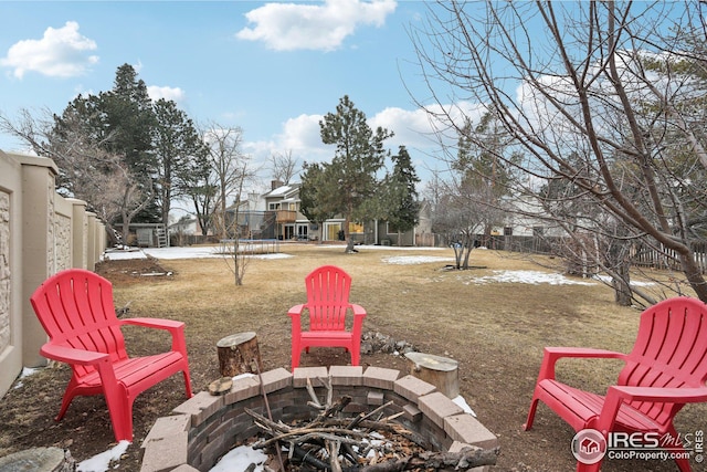 view of yard featuring fence and a fire pit