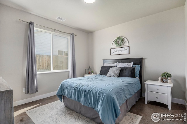 bedroom featuring visible vents and baseboards