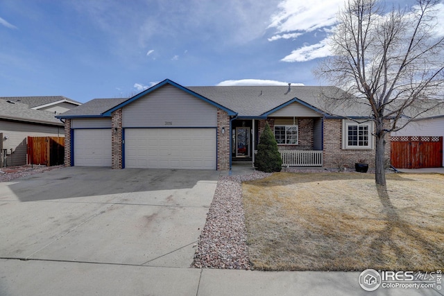 single story home with driveway, brick siding, an attached garage, and fence