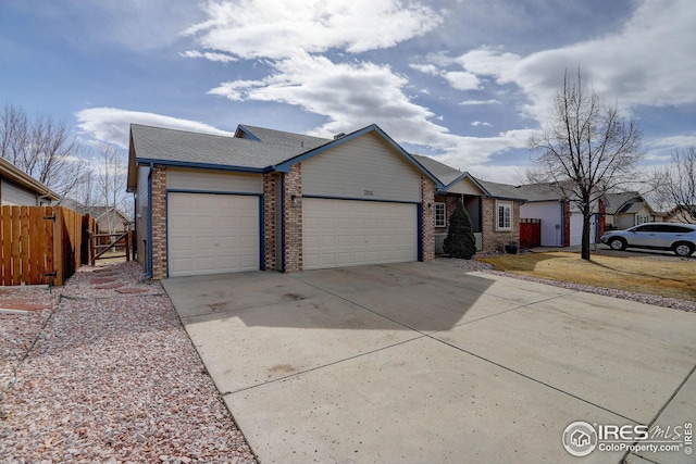 single story home featuring an attached garage, brick siding, fence, driveway, and roof with shingles