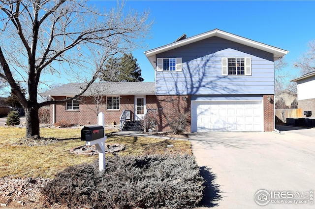 view of front of property with a garage, brick siding, and driveway