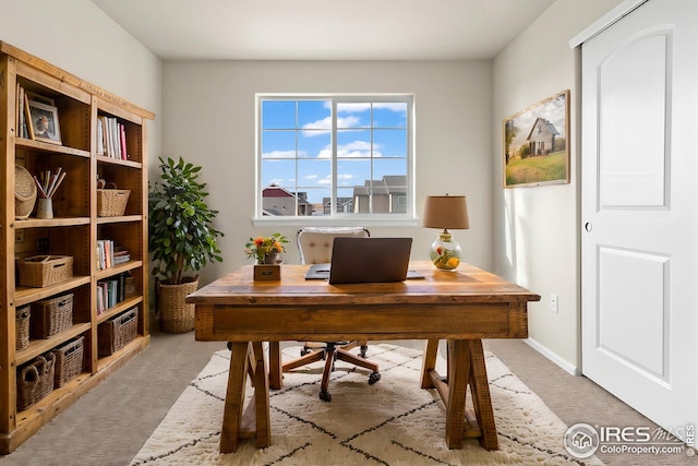 office space featuring light colored carpet and baseboards