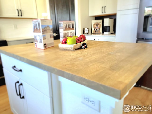 kitchen with light countertops, white cabinetry, and a kitchen island